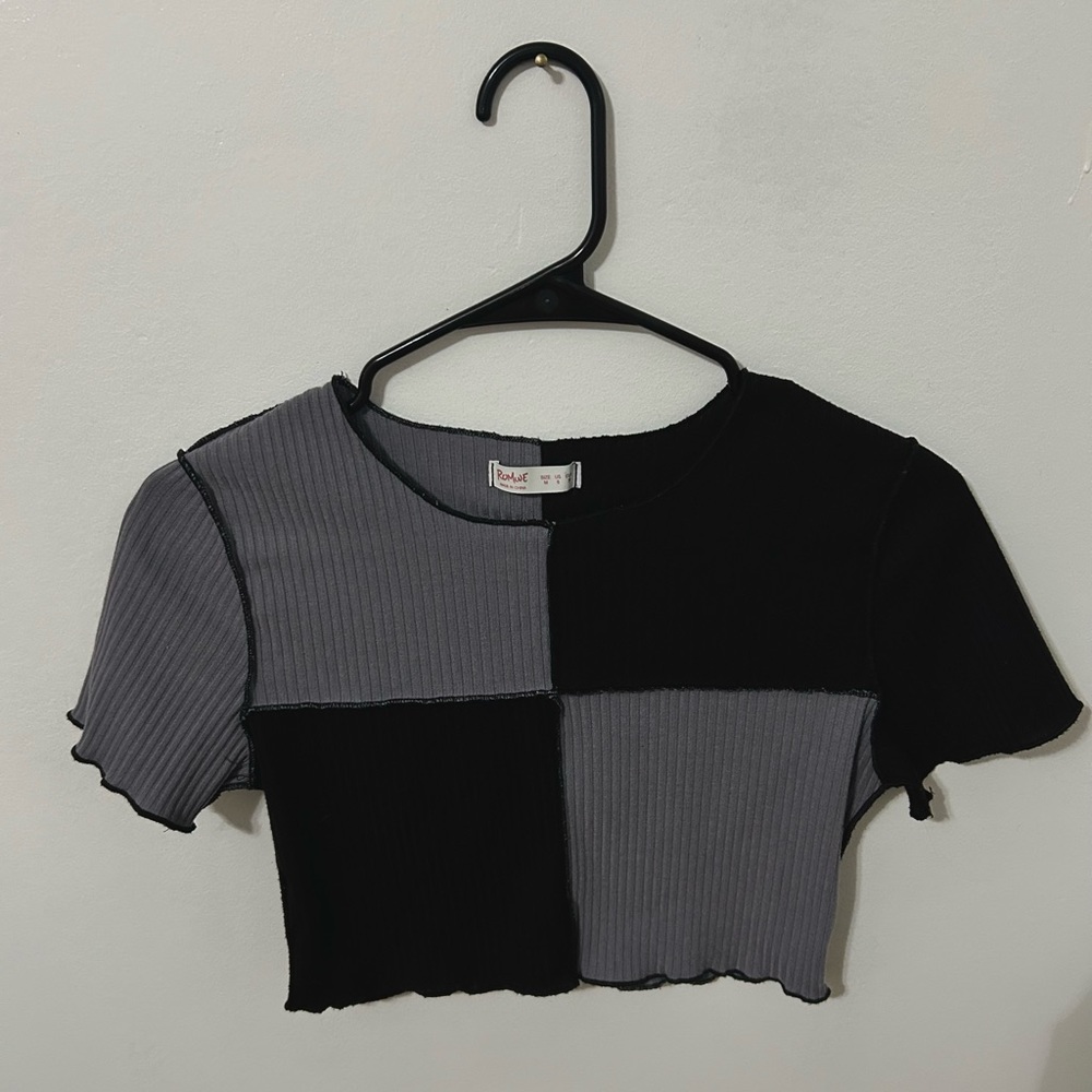 This is a gray and black cropped, women’s/teen girl, top size Medium from Romwe.